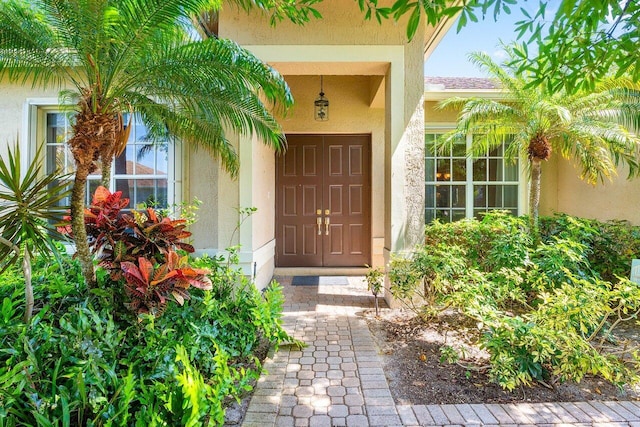 property entrance with stucco siding
