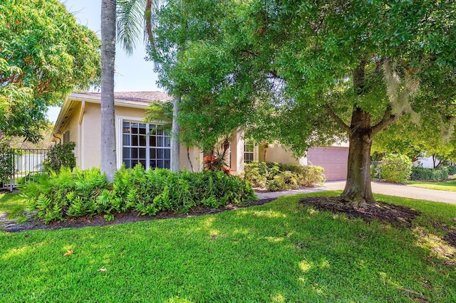 obstructed view of property with stucco siding and driveway