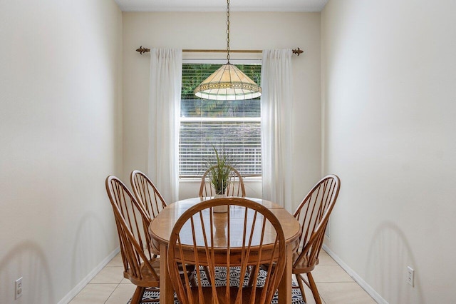 dining space with light tile patterned floors and baseboards