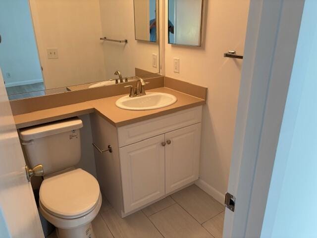 half bathroom with toilet, vanity, and tile patterned floors