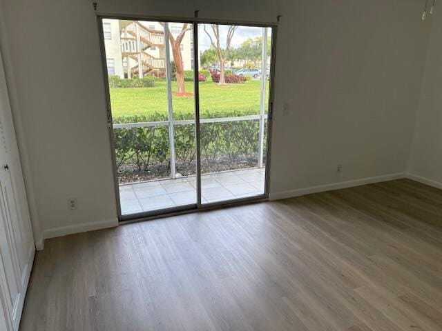 unfurnished dining area with wood finished floors and baseboards