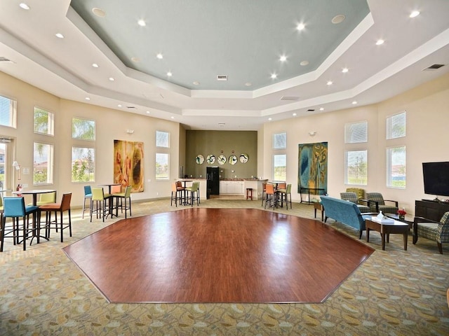 2172 Harwick Cir SW, Vero Beach, FL 32968 - exercise room featuring a tray ceiling, a high ceiling, and recessed lighting