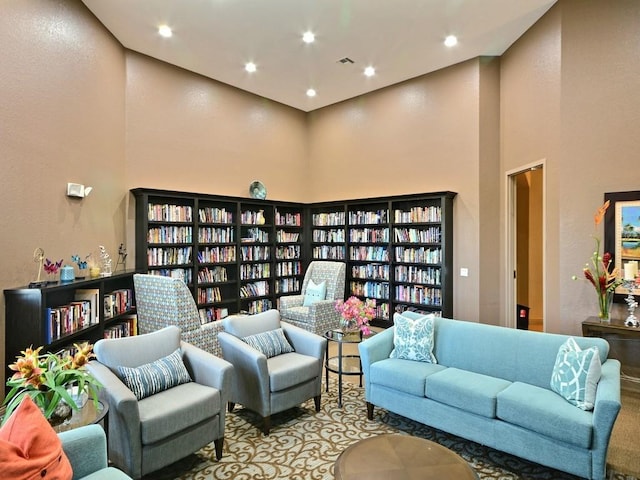 2172 Harwick Cir SW, Vero Beach, FL 32968 - living area featuring a towering ceiling, wall of books, and recessed lighting