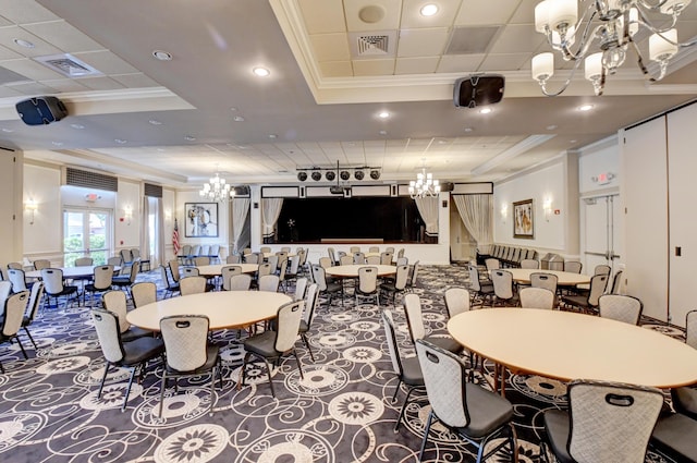 dining room featuring a chandelier, a tray ceiling, crown molding, and recessed lighting