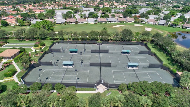aerial view of property's location featuring nearby suburban area, a nearby body of water, and a local golf course