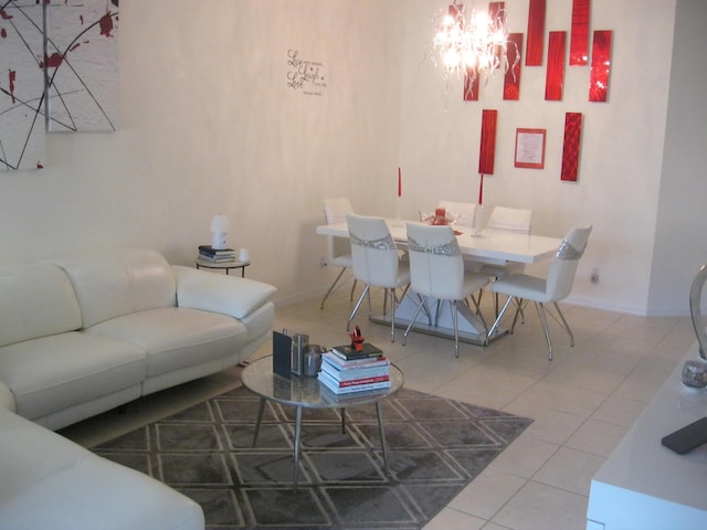 tiled living area featuring a chandelier and baseboards
