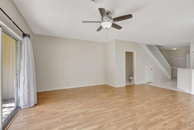 unfurnished living room with light wood-type flooring, ceiling fan, and baseboards