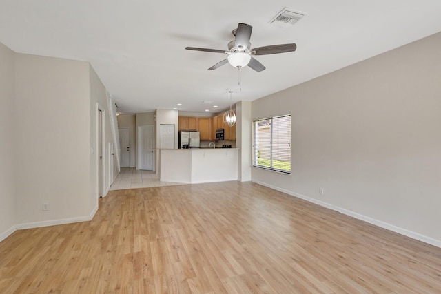 unfurnished living room with baseboards, ceiling fan, light wood-style floors, and recessed lighting