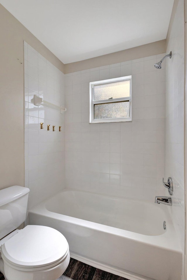 full bathroom featuring  shower combination, toilet, and wood finished floors