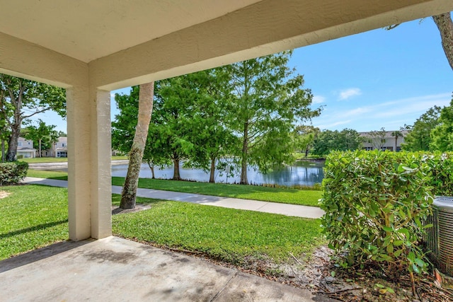 view of patio with a water view and central AC unit