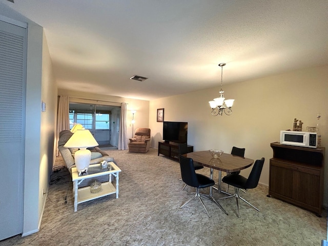 living room featuring a chandelier and carpet