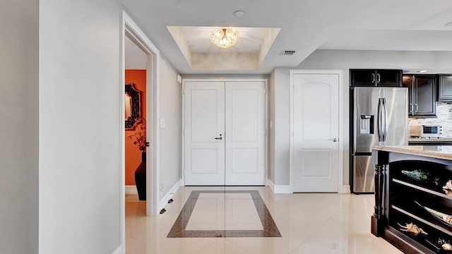 4740 S Ocean Blvd Unit 710, Highland Beach, FL 33487 - foyer with baseboards and a raised ceiling