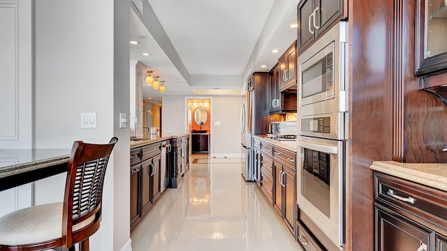 4740 S Ocean Blvd Unit 710, Highland Beach, FL 33487 - kitchen featuring appliances with stainless steel finishes, recessed lighting, glass insert cabinets, and dark brown cabinetry