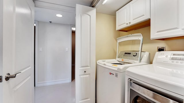 4740 S Ocean Blvd Unit 710, Highland Beach, FL 33487 - washroom with cabinet space, washer and dryer, tile patterned flooring, and recessed lighting