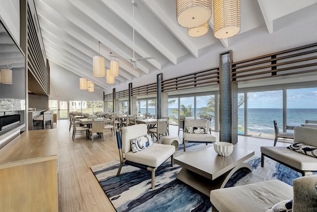 4740 S Ocean Blvd Unit 710, Highland Beach, FL 33487 - living area featuring beamed ceiling, healthy amount of natural light, high vaulted ceiling, wood finished floors, and a ceiling fan