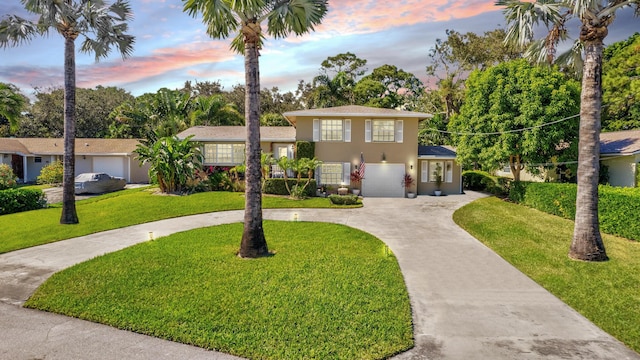 14109 Leeward Way, Palm Beach Gardens, FL 33410 - split level home with curved driveway, stucco siding, and a front lawn
