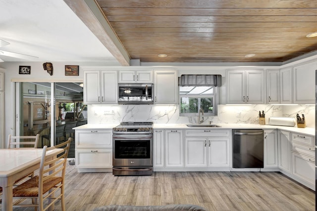 14109 Leeward Way, Palm Beach Gardens, FL 33410 - kitchen featuring appliances with stainless steel finishes, a sink, wooden ceiling, light countertops, and white cabinets