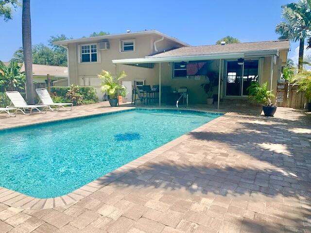 14109 Leeward Way, Palm Beach Gardens, FL 33410 - outdoor pool featuring a patio, fence, and a wall unit AC