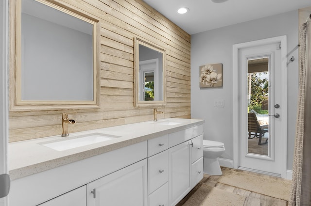 1560 SW 16th St, Boca Raton, FL 33486 - full bath with wooden walls, toilet, double vanity, baseboards, and recessed lighting