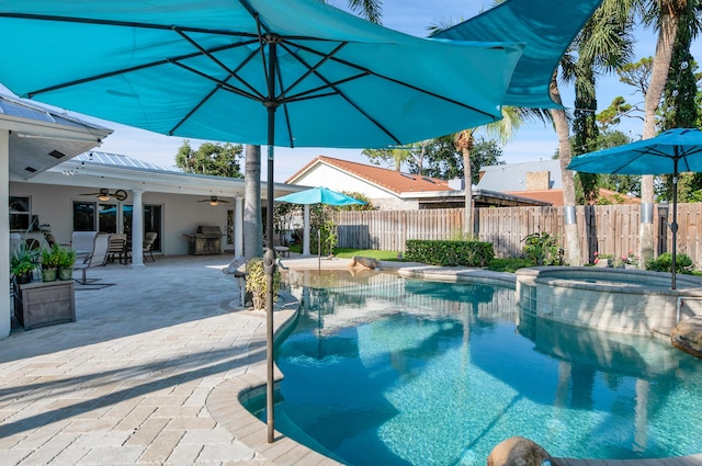 1560 SW 16th St, Boca Raton, FL 33486 - view of pool with ceiling fan, fence, a patio, a pool with connected hot tub, and a grill