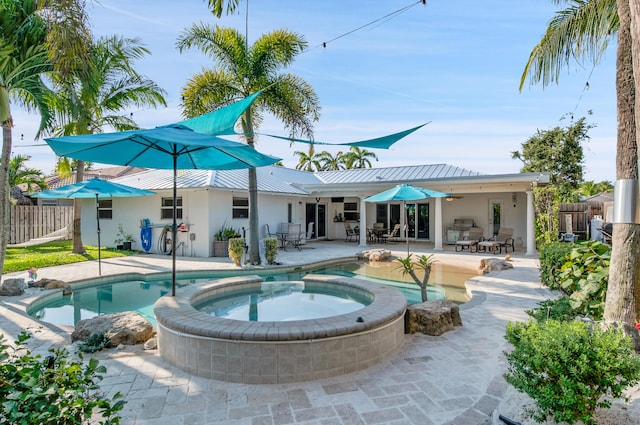 1560 SW 16th St, Boca Raton, FL 33486 - view of swimming pool with fence, a patio area, outdoor dining area, a pool with connected hot tub, and a ceiling fan