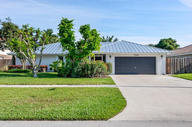 1560 SW 16th St, Boca Raton, FL 33486 - view of front of home with stucco siding, a standing seam roof, an attached garage, and driveway