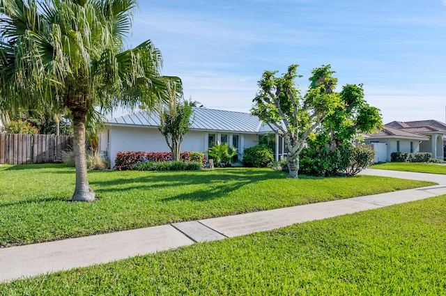 1560 SW 16th St, Boca Raton, FL 33486 - view of front of home featuring stucco siding and metal roof