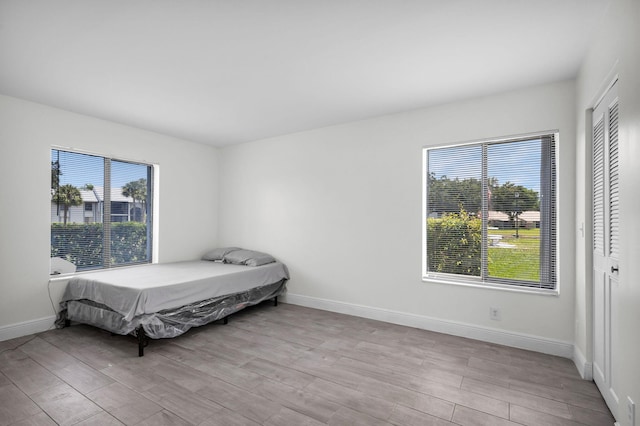 1011 Green Pine Blvd Unit G1, West Palm Beach, FL 33409 - bedroom featuring baseboards and light wood-type flooring
