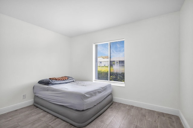 1011 Green Pine Blvd Unit G1, West Palm Beach, FL 33409 - bedroom with baseboards and wood finished floors