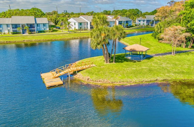 1011 Green Pine Blvd Unit G1, West Palm Beach, FL 33409 - dock featuring a water view, a residential view, and a lawn