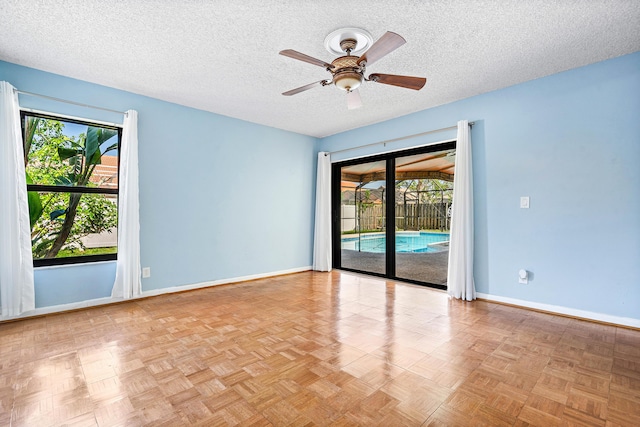21212 Escondido Way, Boca Raton, FL 33433 - unfurnished room featuring a ceiling fan, baseboards, and a textured ceiling