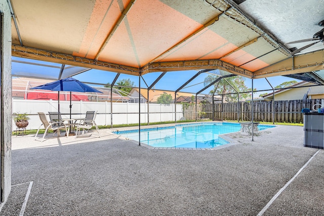 21212 Escondido Way, Boca Raton, FL 33433 - view of swimming pool featuring a patio, a fenced backyard, and glass enclosure