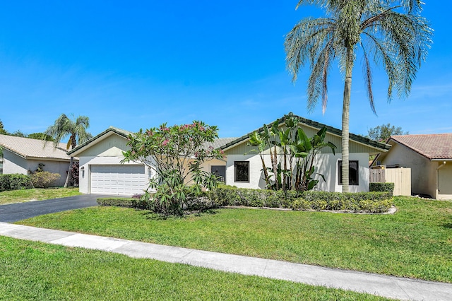 21212 Escondido Way, Boca Raton, FL 33433 - view of front facade featuring asphalt driveway, an attached garage, a front yard, a tiled roof, and stucco siding