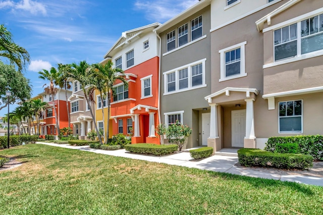 609 Amador Ln Unit 4, West Palm Beach, FL 33401 - townhome / multi-family property featuring stucco siding, a front yard, and a residential view