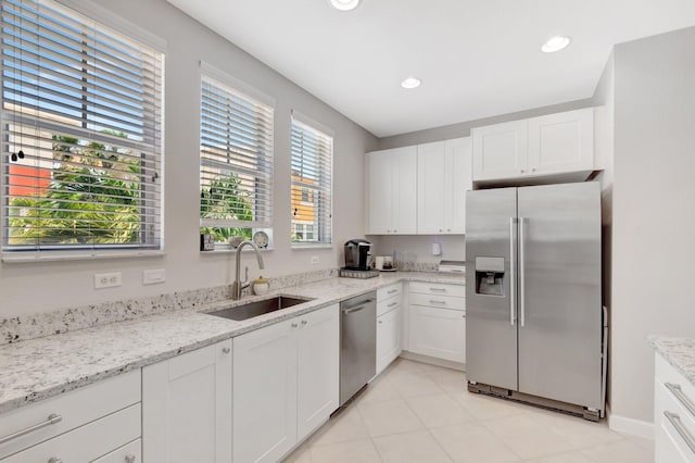 609 Amador Ln Unit 4, West Palm Beach, FL 33401 - kitchen featuring appliances with stainless steel finishes, a sink, white cabinetry, light stone countertops, and recessed lighting