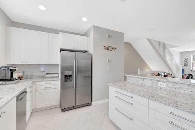 609 Amador Ln Unit 4, West Palm Beach, FL 33401 - kitchen with appliances with stainless steel finishes, white cabinets, light stone countertops, baseboards, and recessed lighting