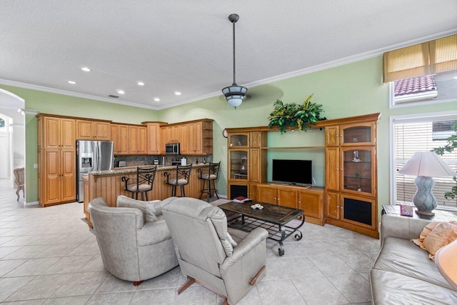 living room with light tile patterned floors, ornamental molding, a textured ceiling, and recessed lighting