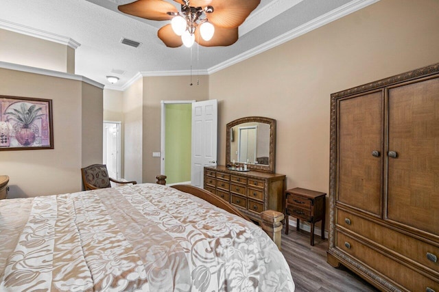 bedroom with dark wood-style floors, crown molding, a textured ceiling, and ceiling fan