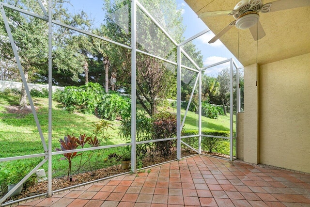 unfurnished sunroom with a ceiling fan