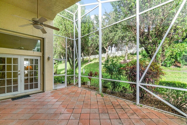 unfurnished sunroom featuring french doors and ceiling fan