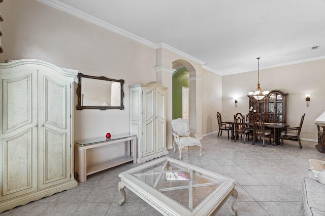 living area with ornate columns, arched walkways, crown molding, light tile patterned floors, and a chandelier
