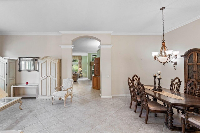 dining room featuring arched walkways, a chandelier, ornamental molding, light tile patterned floors, and baseboards