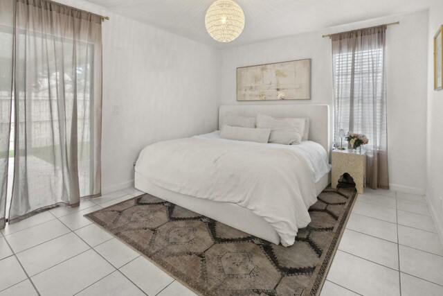 116 Sherwood Cir Unit 7A, Jupiter, FL 33458 - bedroom featuring light tile patterned flooring and baseboards
