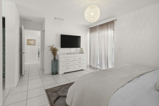 116 Sherwood Cir Unit 7A, Jupiter, FL 33458 - bedroom with a chandelier, light tile patterned floors, and baseboards
