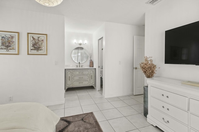 116 Sherwood Cir Unit 7A, Jupiter, FL 33458 - bedroom featuring light tile patterned floors, a sink, baseboards, and connected bathroom