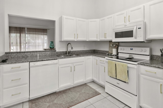 116 Sherwood Cir Unit 7A, Jupiter, FL 33458 - kitchen featuring white appliances, a sink, white cabinets, light tile patterned flooring, and dark stone countertops