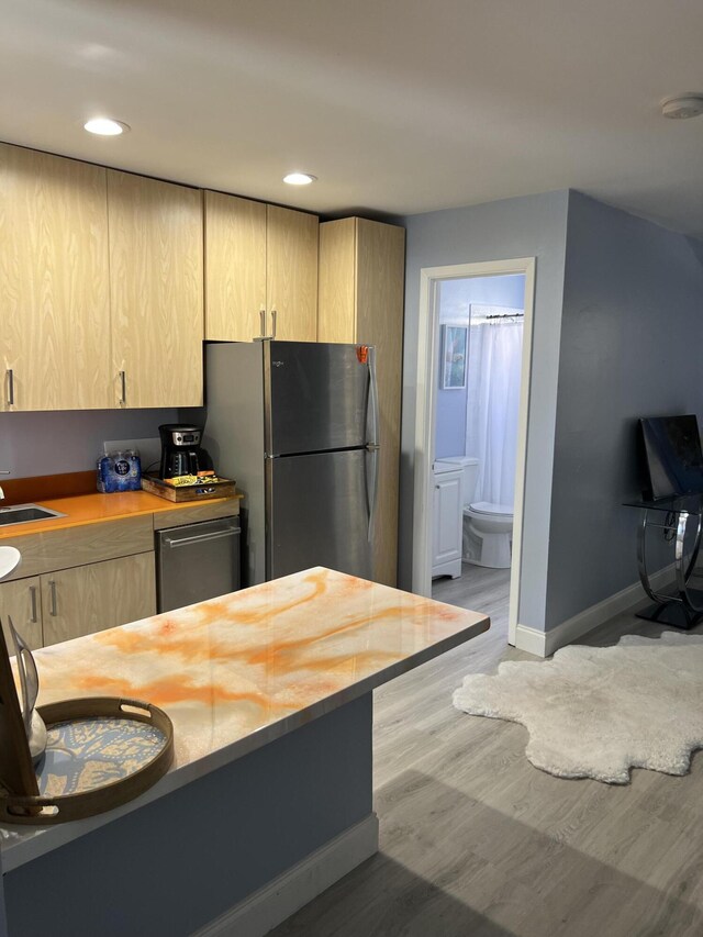 1081 SE Monterey Rd Unit 3-17, Stuart, FL 34994 - kitchen featuring light brown cabinets, stainless steel appliances, light wood finished floors, baseboards, and recessed lighting