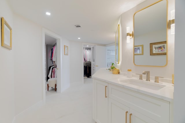 100 Lakeshore Dr Unit 1954, North Palm Beach, FL 33408 - bathroom with vanity, a walk in closet, recessed lighting, and baseboards