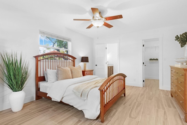 4060 Lake Dr, Coconut Creek, FL 33066 - bedroom featuring light wood-style floors, a spacious closet, ceiling fan, and ensuite bath
