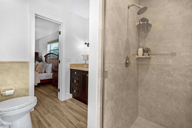 4060 Lake Dr, Coconut Creek, FL 33066 - bathroom featuring a shower stall, connected bathroom, toilet, vanity, and tile walls